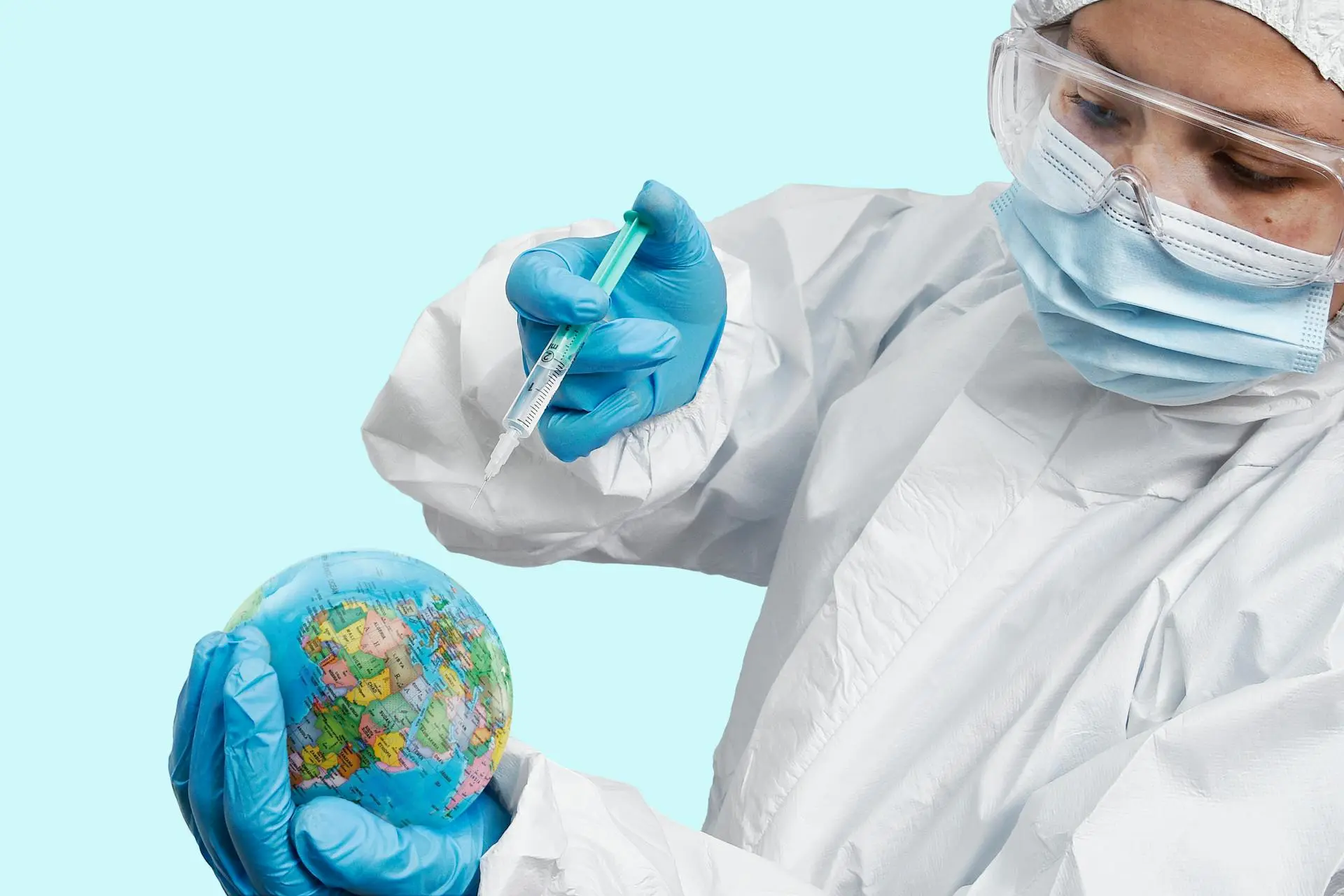 A-Person-in-a-PPE-Injecting-a-Vaccine-into-a-Globe.webp